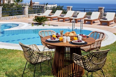 Outside dining table by the pool area with panoramic seaview