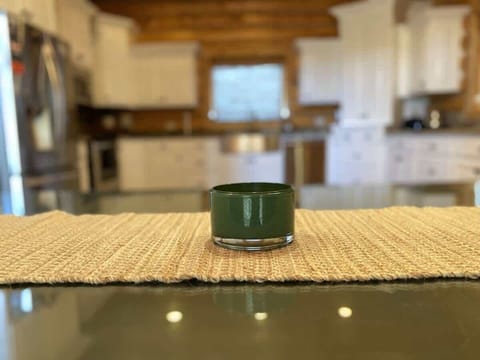 Imagine a cozy kitchen in a cabin, where the soft flicker of a candle adds a touch of warmth and intimacy to the rustic space.