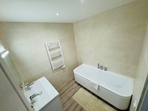 Comfort Suite | Bathroom | Bathtub, hair dryer, towels, soap