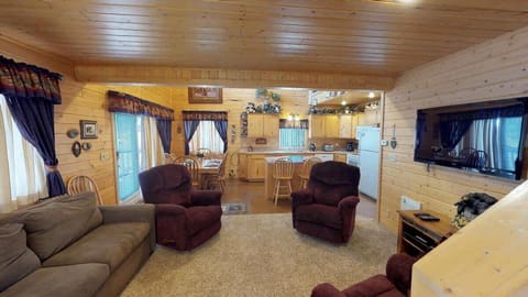 The open living rooms blends seamlessly into the cabin's cozy kitchen, creating a welcoming space perfect for gathering and unwinding.