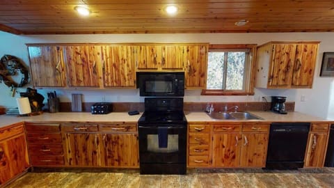 Kitchen is full of appliances, cookware, dishes, and all of your cooking needs.