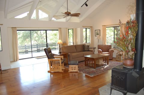 Living Room with cathedral ceilings and expansive deck and views.