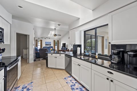 New well stocked kitchen with skylights and view to family room and laundry. 