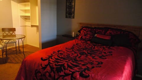 Spacious bedroom that includes queen bed and table and chairs