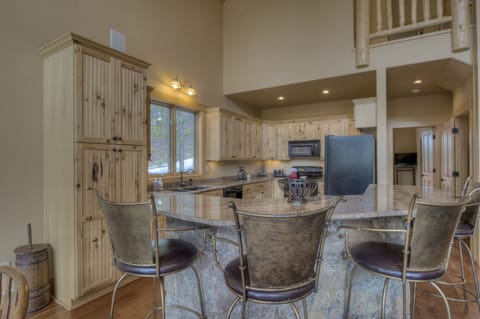 Kitchen w/ master bedroom door in the background.