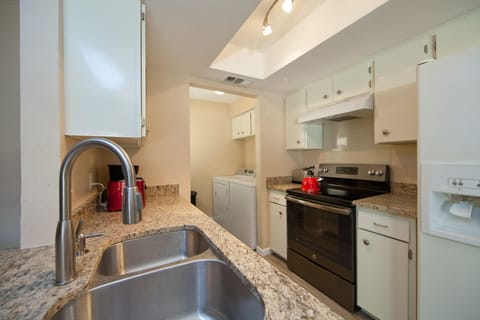Kitchen area, microwave, toaster, washer and dryer.