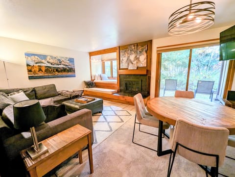 Living room and dining area looking out onto the private patio with view of window seat/daybed (1)
