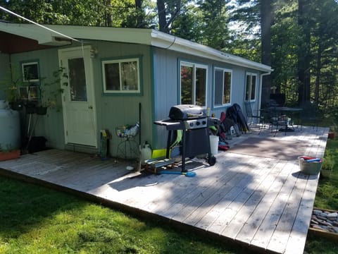 Lake side of house, grills, deck, table and chairs
