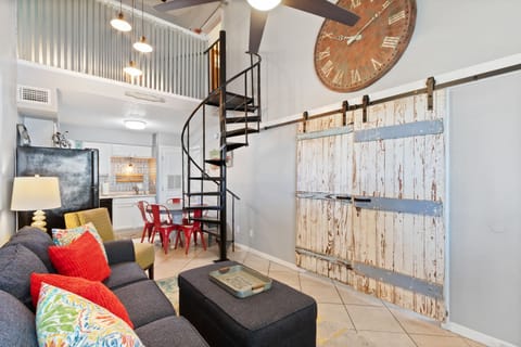 Open concept living room. Barn doors open to main floor bedroom.