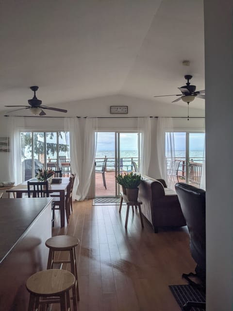 Bright open-concept waterfront living room with scenic panoramic daytime views. 