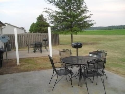 Back Patio with charcoal grill and fire pit.
