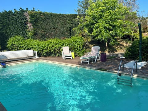 Seasonal outdoor pool, open 3:30 PM to 7:00 PM, pool umbrellas