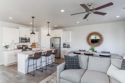 Living Room View - The Kitchen Island comfortably seats 3 adults and creates a great space for serving and preparing meals.