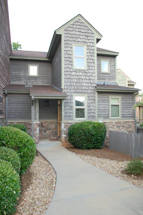 Elegant stacked stone and cedar Craftsman exterior.
