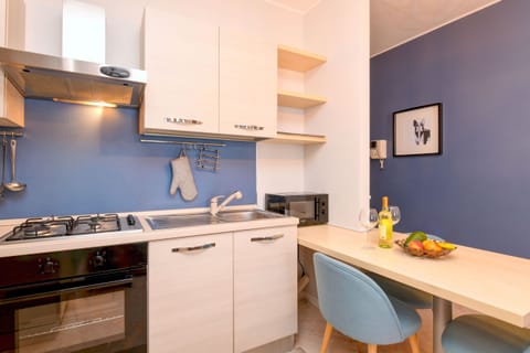 Kitchen equipped with fridge, oven and microwave