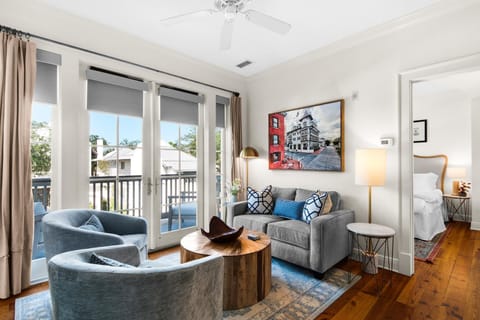 Bright living room with cozy seating and balcony views