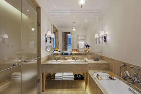 Separate tub and shower, designer toiletries, hair dryer, bathrobes