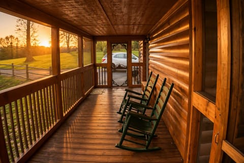 Unwind on the screened‑in porch in the two hunter‑green rockers, an ideal spot for some wine or a peaceful evening outdoors