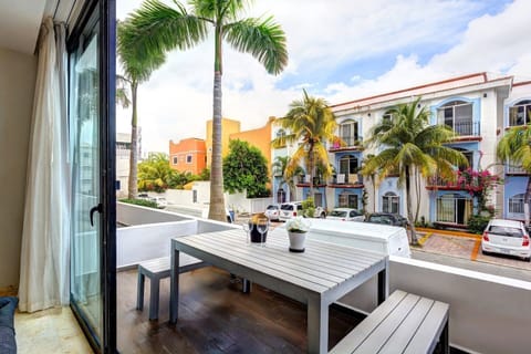 Large balcony facing a calm street, with table and chairs