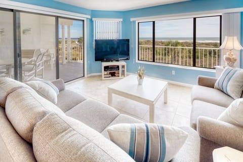 Living Room - View to Porch - Spacious living room with open floor plan and connected balcony featuring a direct view of the ocean.