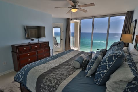 Master bedroom with breathtaking ocean views and private access to balcony.