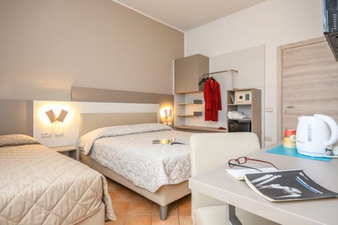 Triple Room | Down comforters, in-room safe, desk, blackout drapes