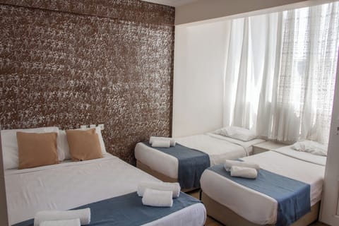 Standard Quadruple Room | Minibar, desk, iron/ironing board, free cribs/infant beds