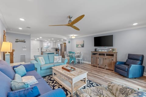 Relax in your coastal-themed living space with ocean-inspired blues, comfortable seating, and modern amenities for perfect beach getaway vibes.