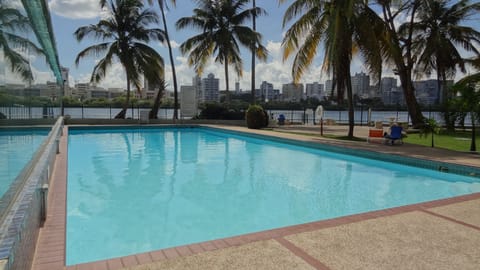 View to the swimming pool, back patio and Condado Lagoon; Sun lounges