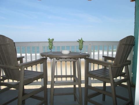 balcony has two tables and four chairs 