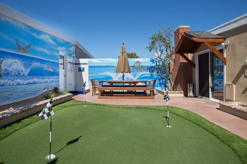 Teak Table is 8 feet and seats 10 with an umbrella. Putting Green