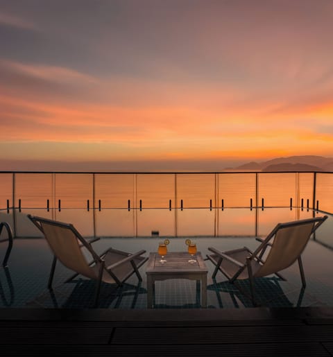 Outdoor pool, open 5 AM to 10:00 PM, pool umbrellas, sun loungers