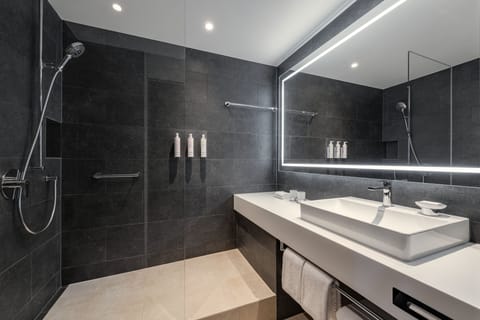 Combined shower/tub, designer toiletries, hair dryer, slippers