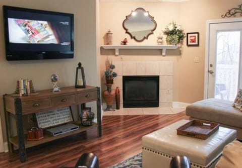 Living area with large flatscreen TV and cozy fireplace