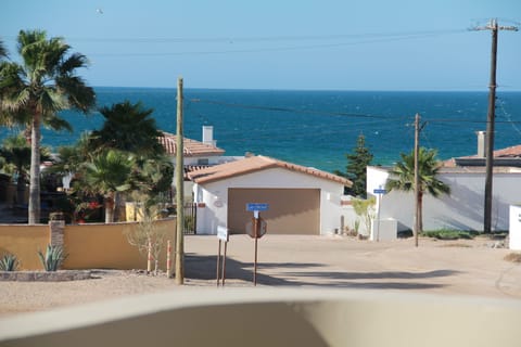 The beach is behind the white house with brown garage door. Only a short walk