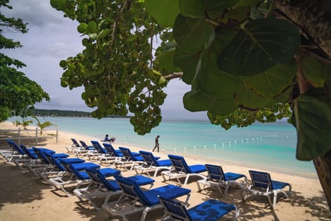 On the beach, white sand, sun loungers, beach towels
