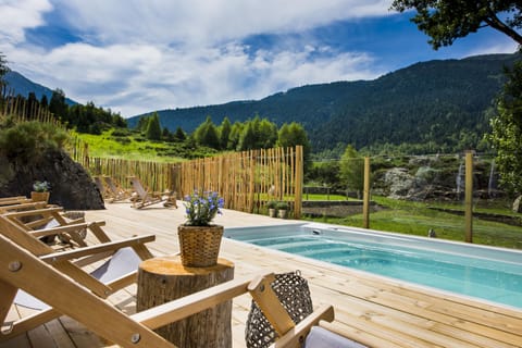 Outdoor pool, open noon to 9:00 PM, pool umbrellas