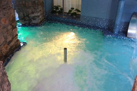 Indoor pool, a waterfall pool, sun loungers