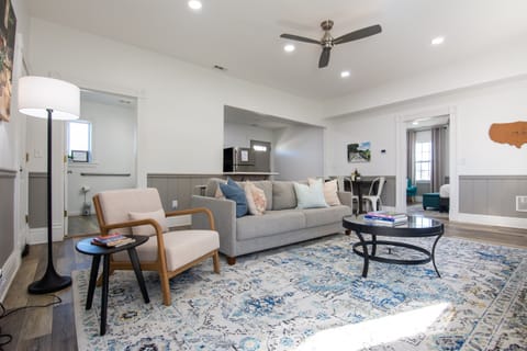 Spacious living area with king size pull out bed, comfy chair, and and abundance of natural light at the Katy Haus.