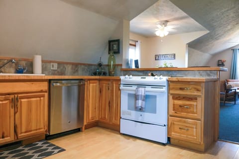 Kitchen with full size dishwasher, refrigerator, and stove