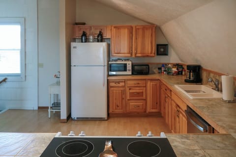 Kitchen with full size dishwasher, refrigerator, and stove