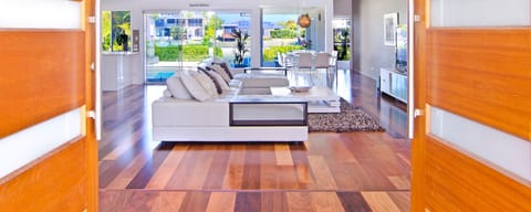 Open-plan lounge with water views and 85" 4K Smart TV