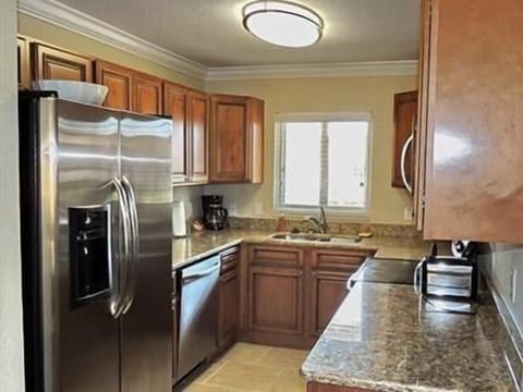 Fully loaded kitchen with granite countertops and stainless steel appliances.