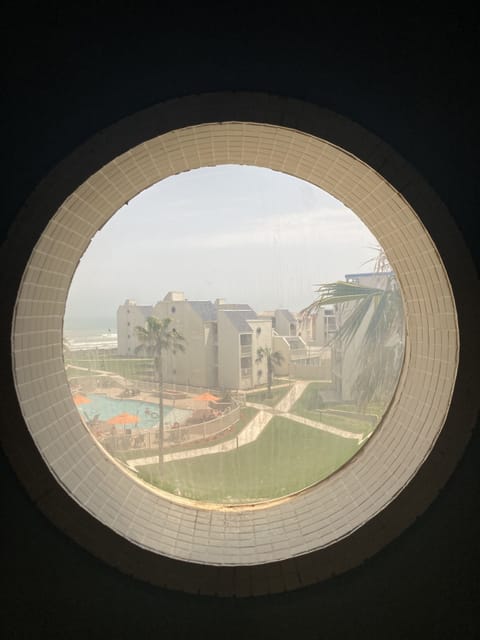 View to the pool from the iconic porthole windows on the stairs
