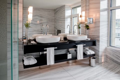 Luxury Living Studio | Bathroom | Rainfall showerhead, designer toiletries, hair dryer, bathrobes