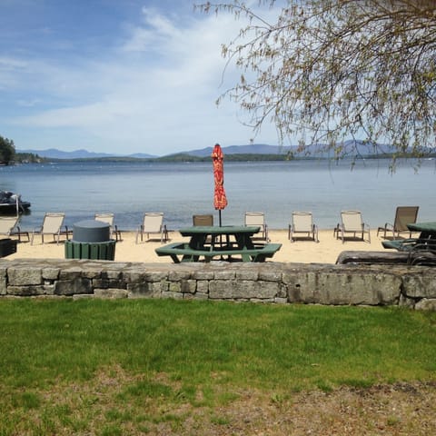 Private beach with chairs, grills, and recreation.