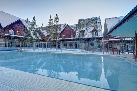 year round outdoor heated pool with hot tub at the entrance