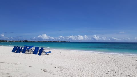 On the beach, white sand, sun loungers, beach umbrellas