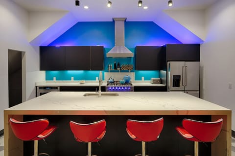 Bar seating and custom kitchen with commercial appliances