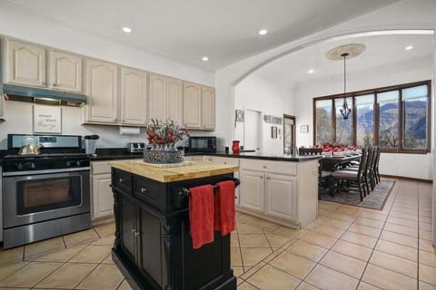 Fully Stocked Kitchen and Dining Room with Bar Seating